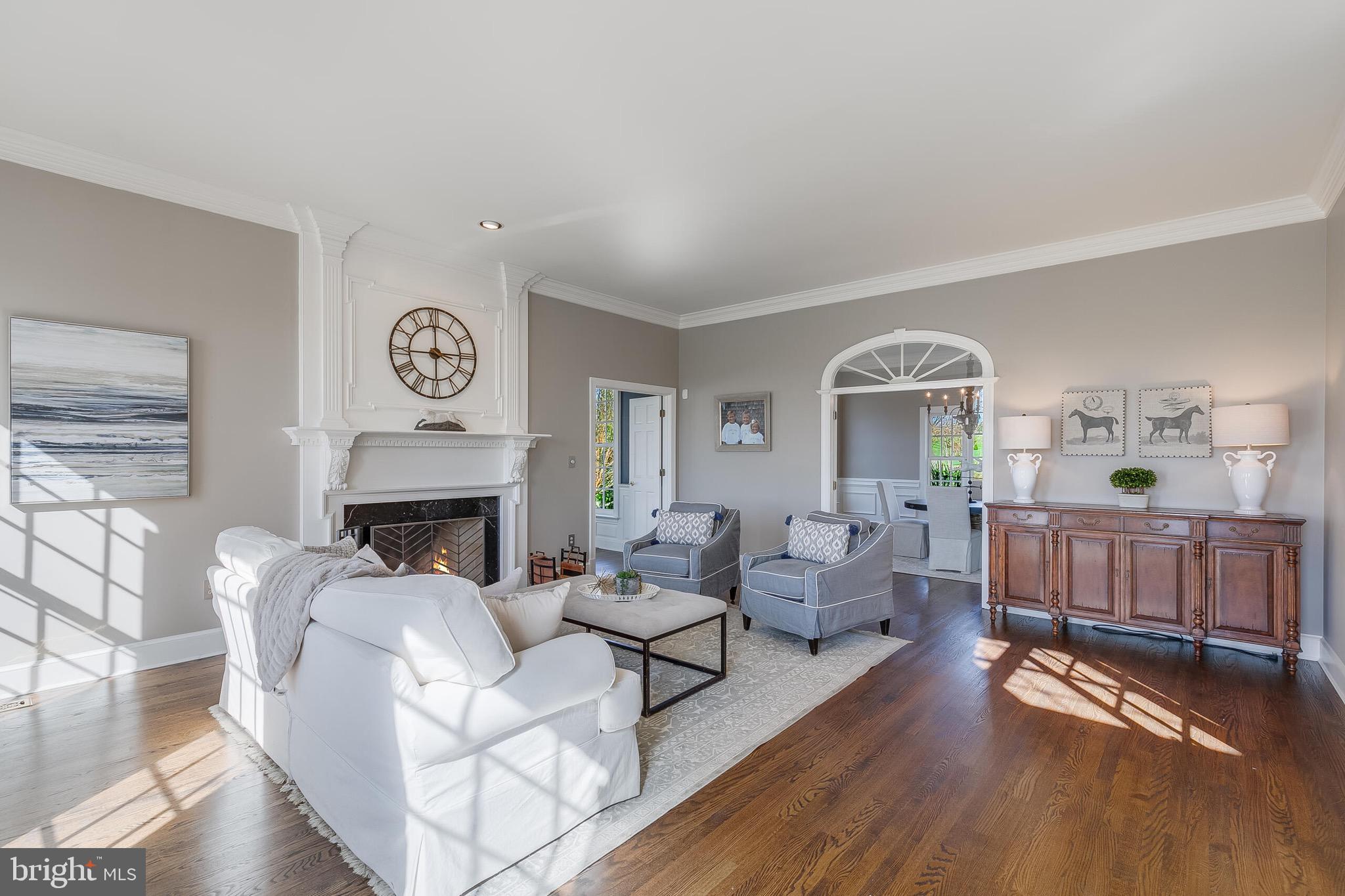15140 Loyalty Road Waterford, VA 20197 - Photo 23 of 60 a living room with furniture a fireplace and a table