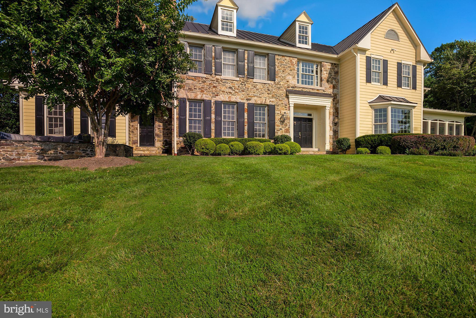 15140 Loyalty Road Waterford, VA 20197 - Photo 50 of 60 front view of a brick house with a yard