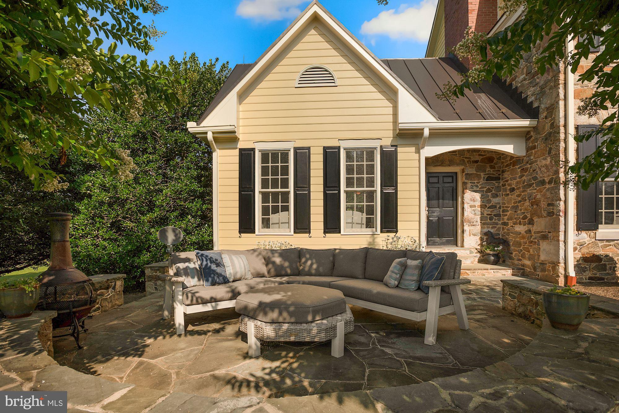 15140 Loyalty Road Waterford, VA 20197 - Photo 52 of 60 a view of a patio with couches and a dining table and chairs with garden view