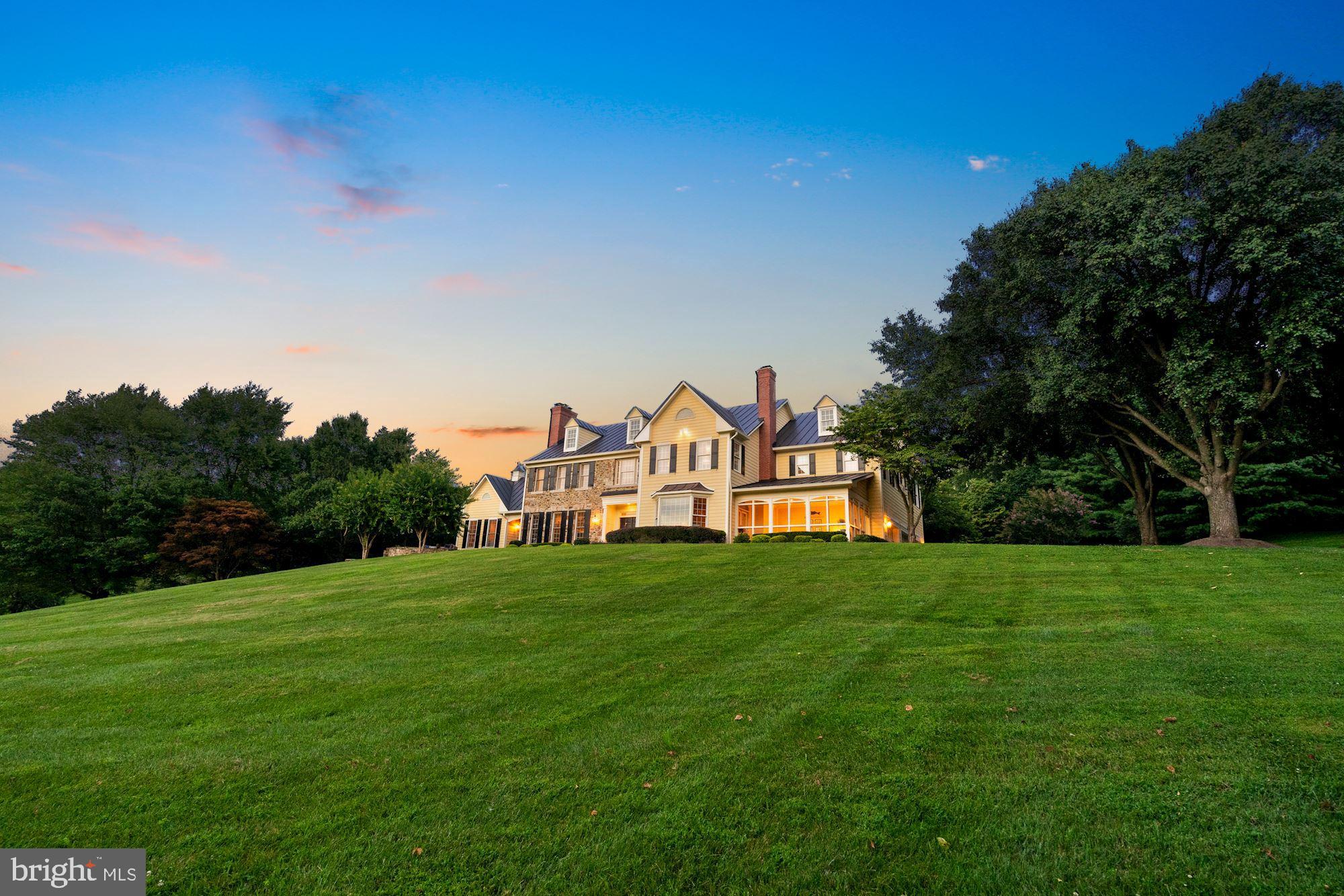 15140 Loyalty Road Waterford, VA 20197 - Photo 6 of 60 a view of a big house with a big yard and large trees