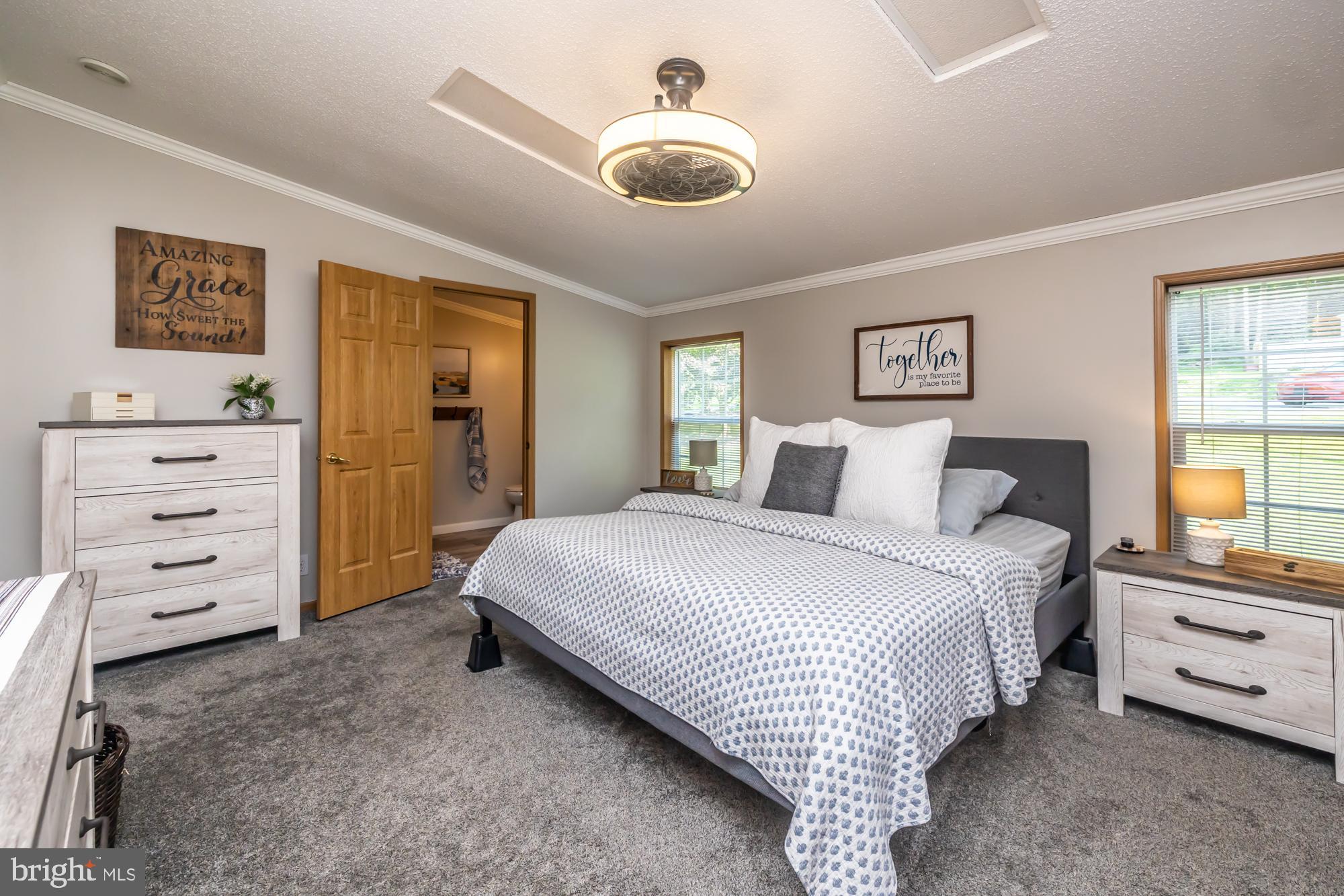239 Quarry Road Gap, PA 17527 - Photo 27 of 48 a bedroom with a bed and a chandelier
