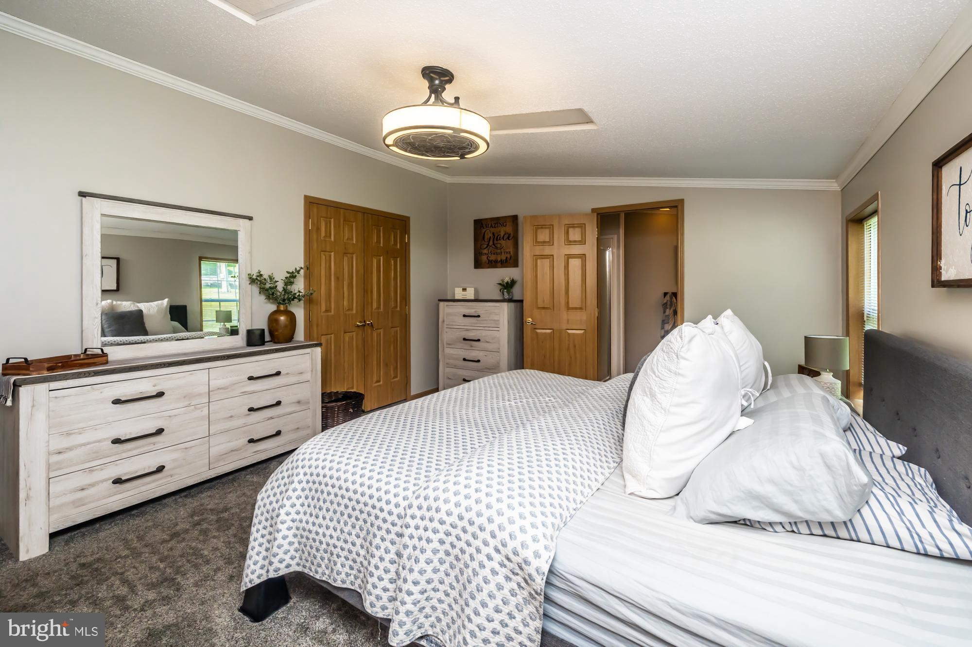 239 Quarry Road Gap, PA 17527 - Photo 28 of 48 a bedroom with a large bed and dresser with mirror
