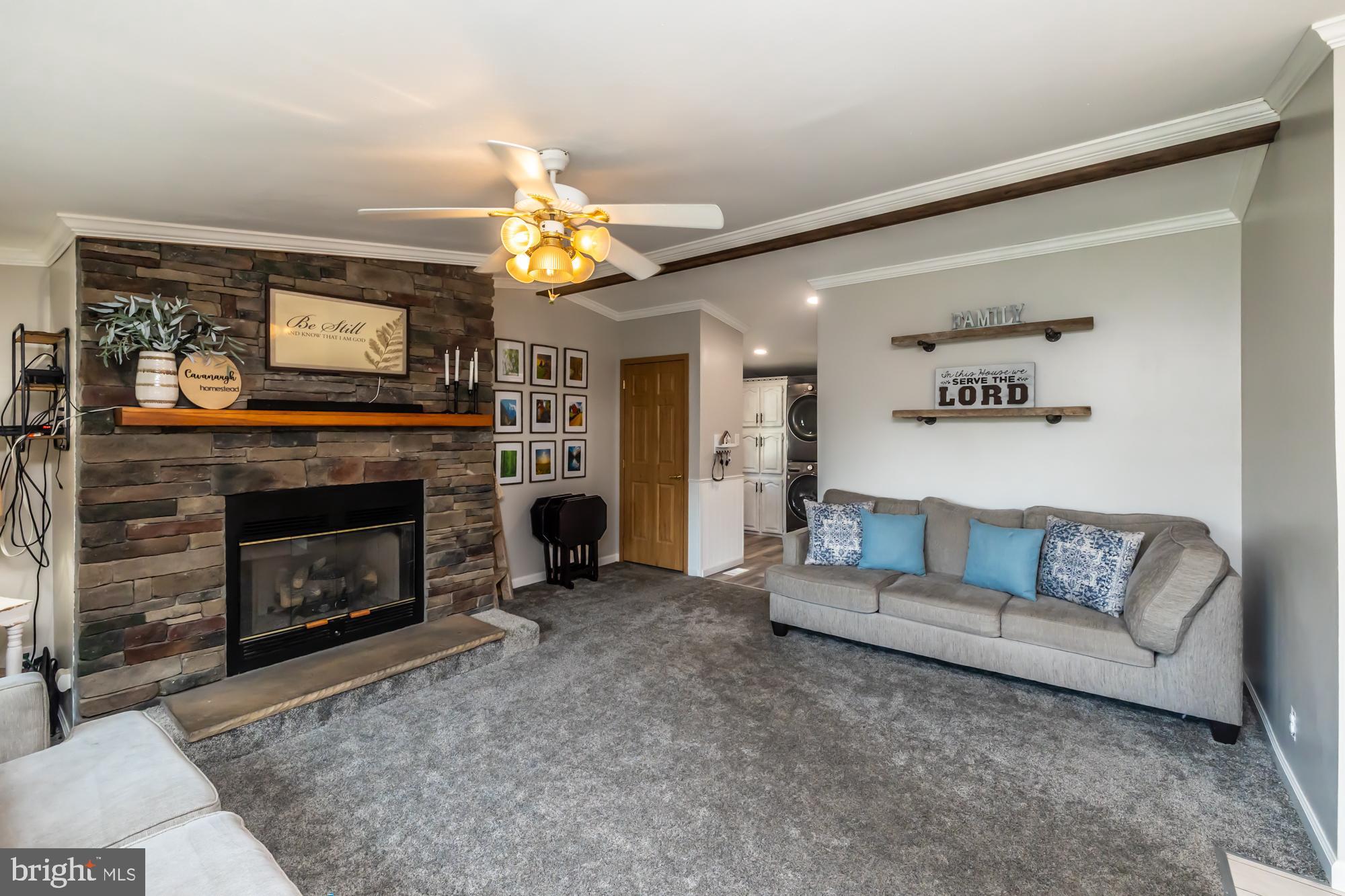 239 Quarry Road Gap, PA 17527 - Photo 4 of 48 a living room with furniture a fireplace and a wall