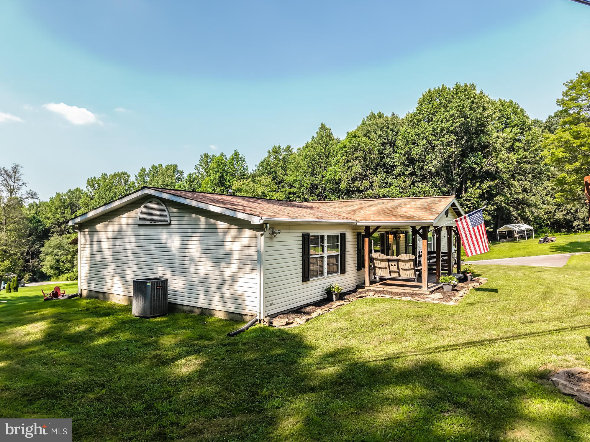239 Quarry Road Gap, PA 17527 - Photo 8 of 48 a view of a house with a yard patio and fire pit