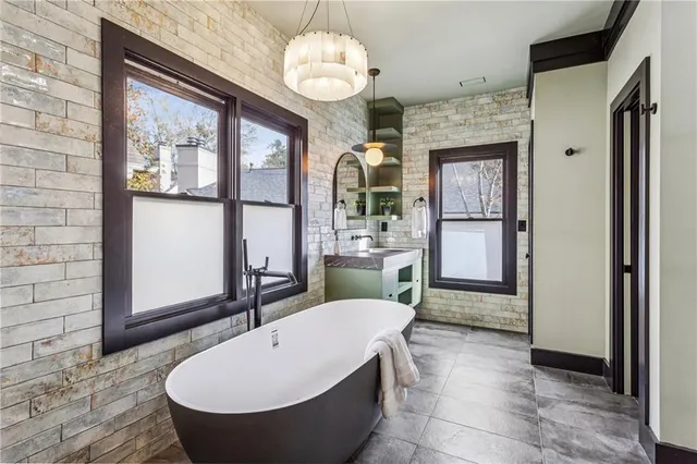 a large room with wooden floor a chandelier a wooden table and chairs