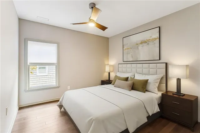 a bedroom with a bed and a night stand