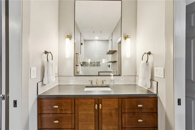 a bathroom with a sink vanity and a mirror