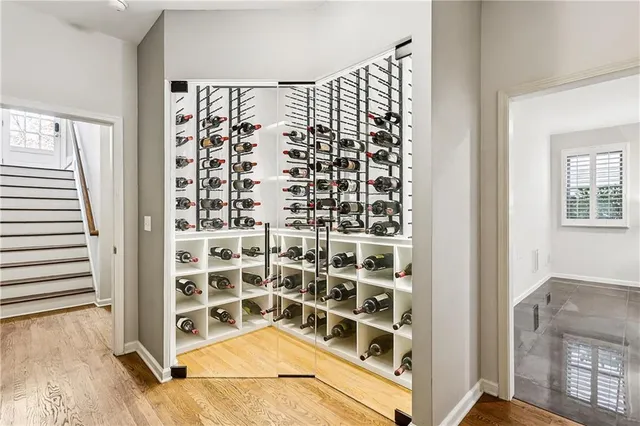 a view of a livingroom with wooden floor and staircase