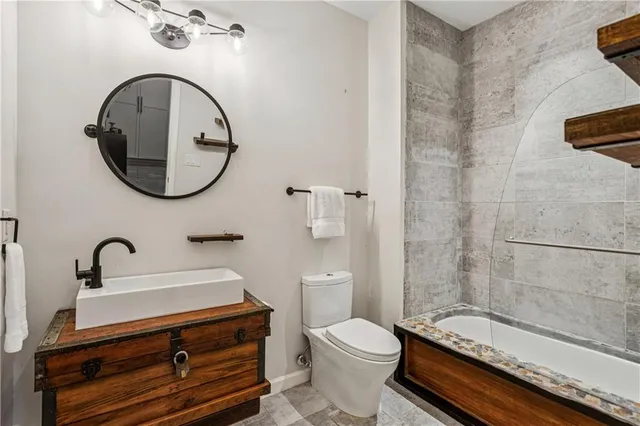 a bathroom with a sink a toilet and a mirror