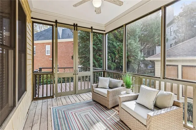 a balcony with couch and wooden floor