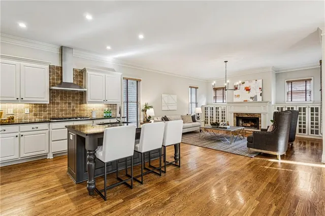a living room with fireplace furniture and a wooden floor
