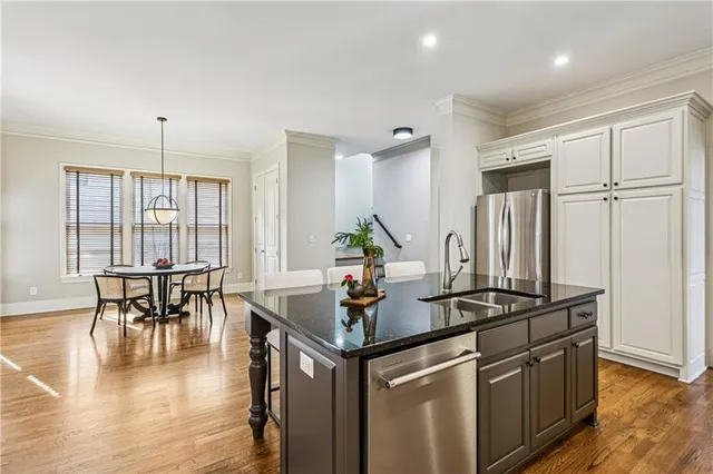 a kitchen with stainless steel appliances granite countertop a stove and a table