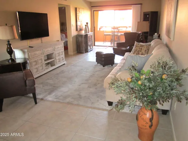 a living room with furniture fireplace and flat screen tv
