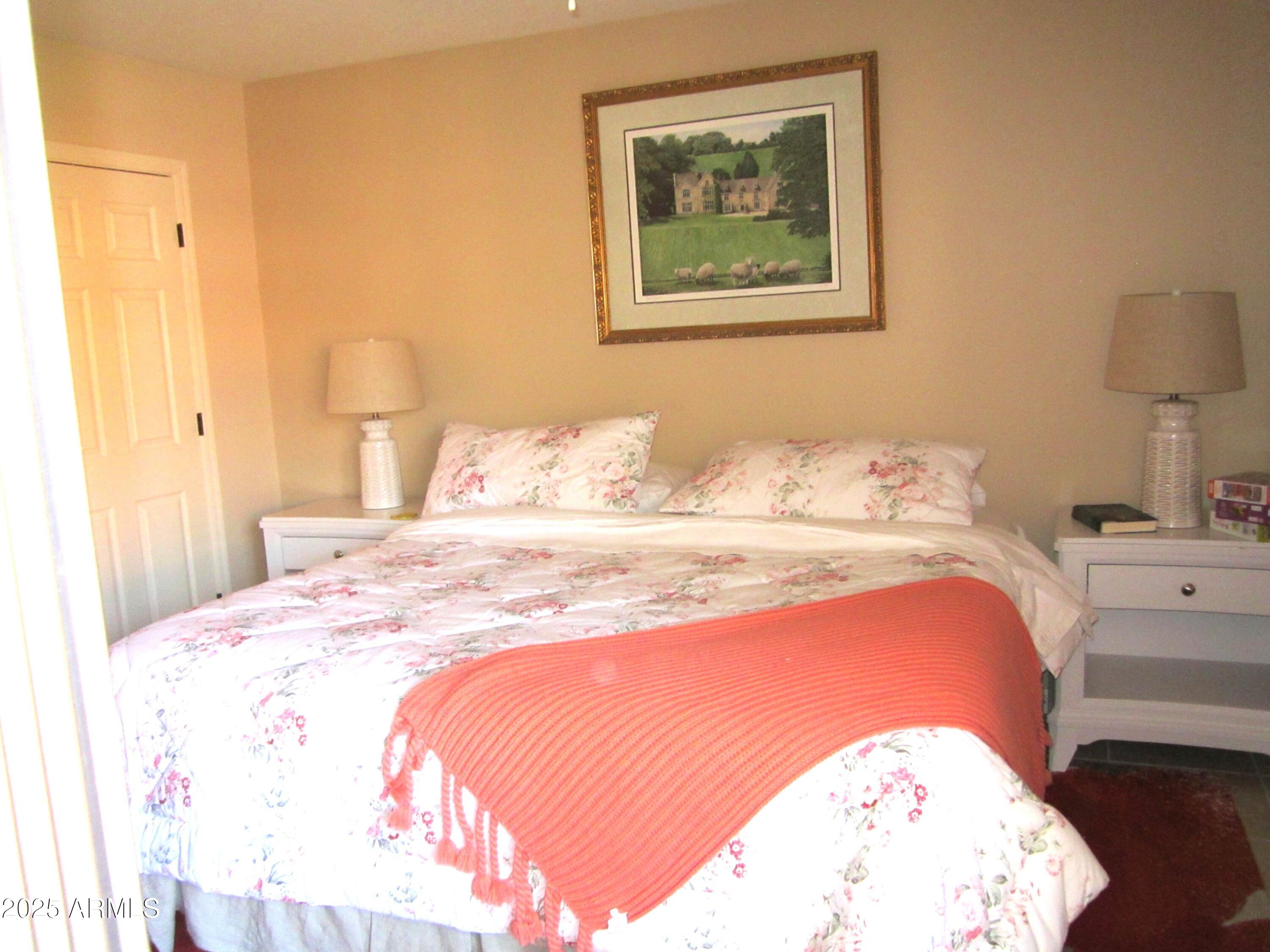 12222 North Paradise Village Parkway West, Unit 325 Phoenix, AZ 85032 - Photo 11 of 28 a bedroom with bed and cupboard