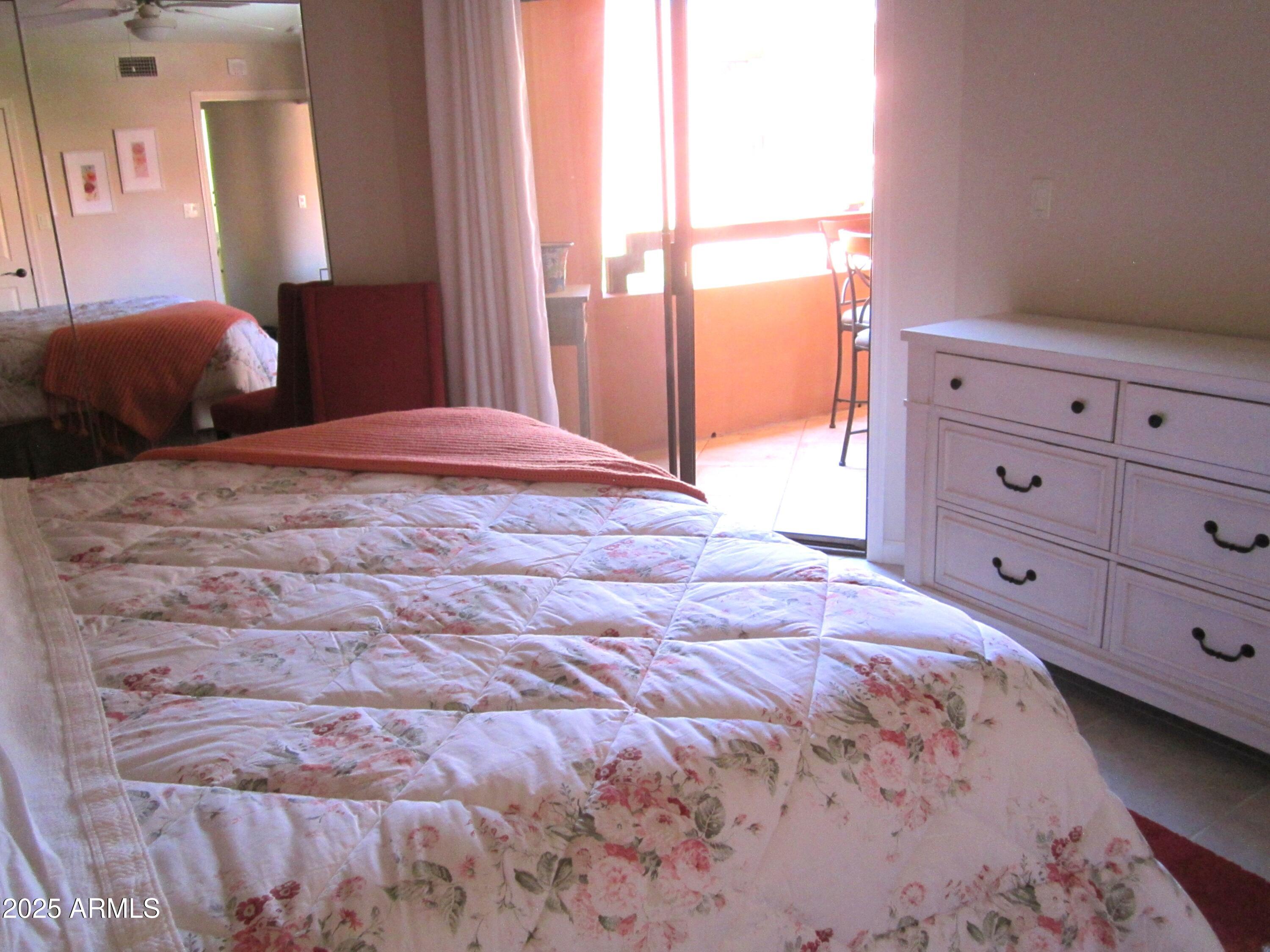 12222 North Paradise Village Parkway West, Unit 325 Phoenix, AZ 85032 - Photo 12 of 28 a bedroom with a bed and a closet