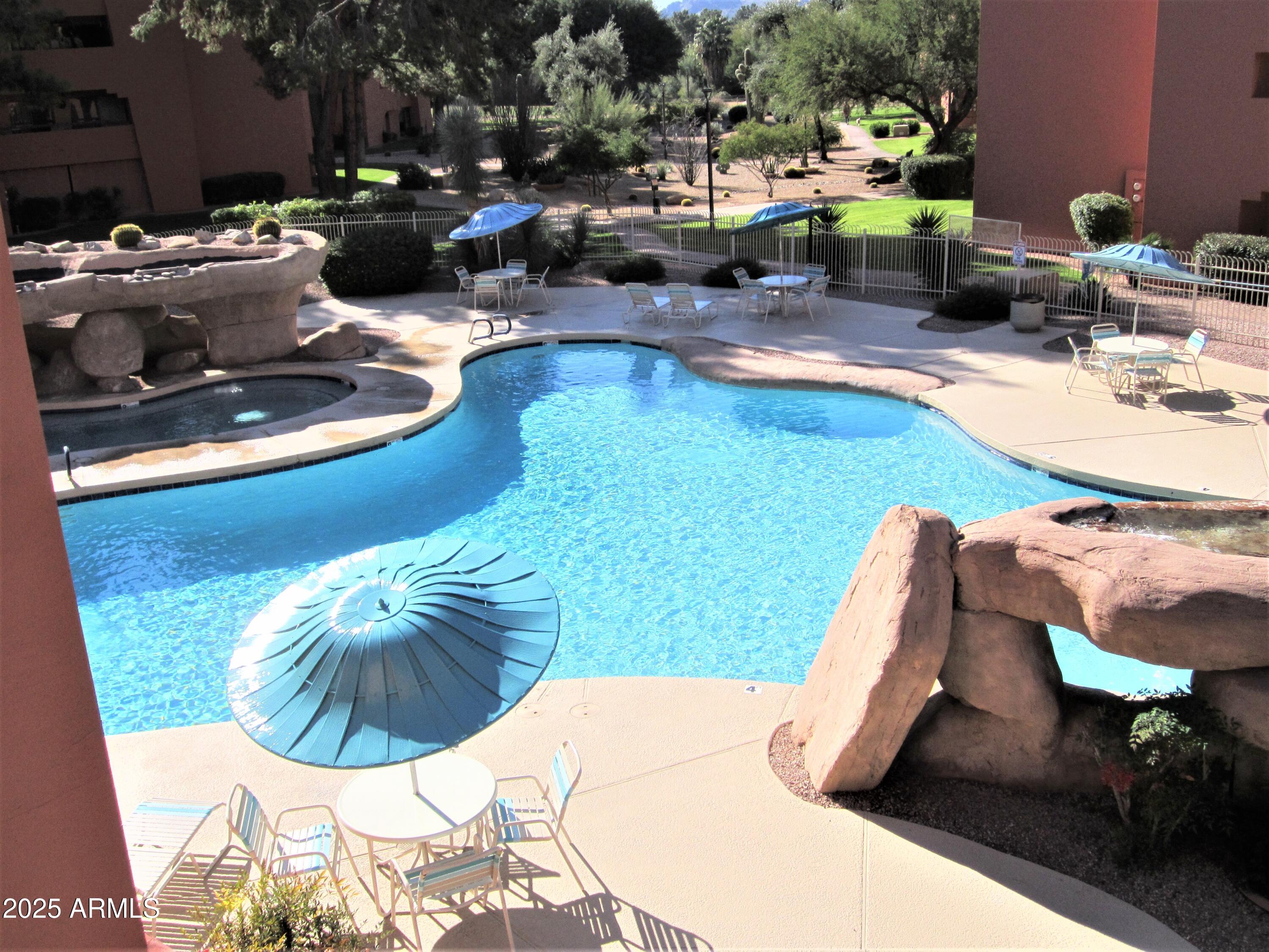 12222 North Paradise Village Parkway West, Unit 325 Phoenix, AZ 85032 - Photo 26 of 28 a view of a swimming pool with lounge chairs
