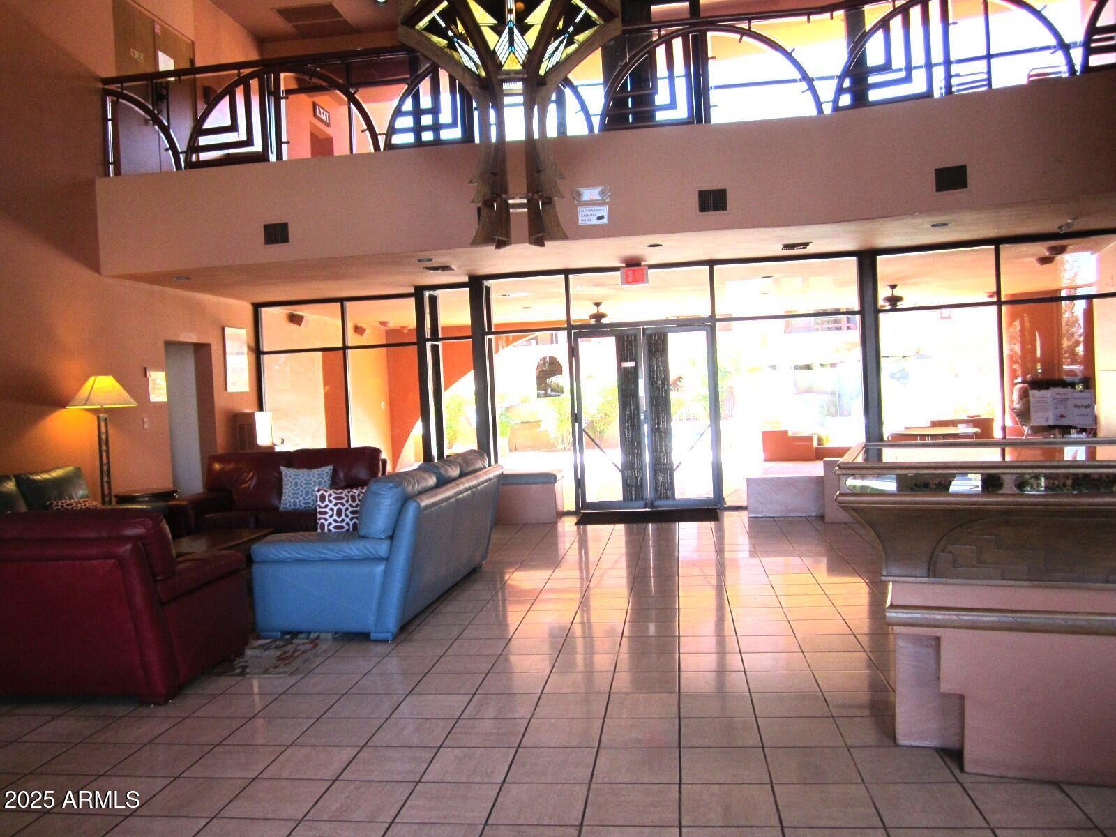 12222 North Paradise Village Parkway West, Unit 325 Phoenix, AZ 85032 - Photo 28 of 28 a living room with fireplace furniture and a large window