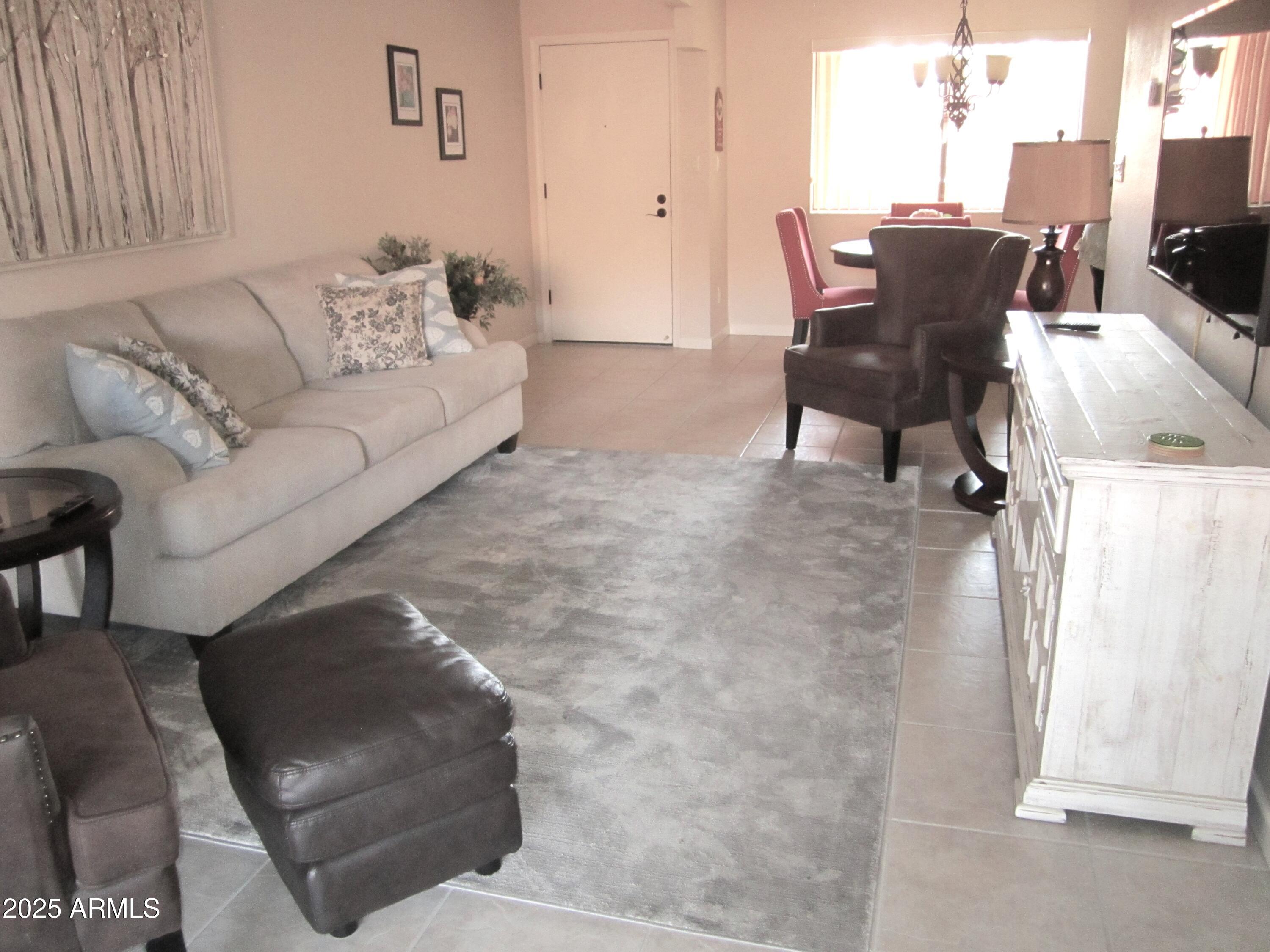 12222 North Paradise Village Parkway West, Unit 325 Phoenix, AZ 85032 - Photo 5 of 28 a living room with furniture and a couch