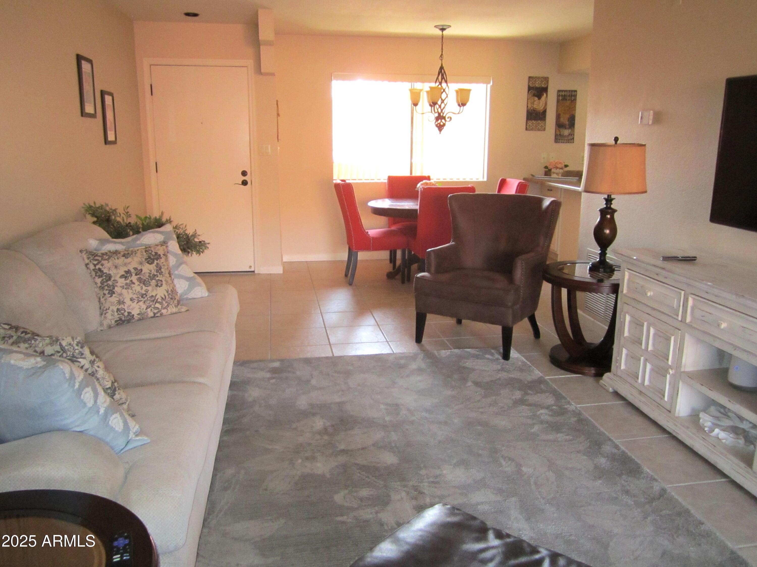 12222 North Paradise Village Parkway West, Unit 325 Phoenix, AZ 85032 - Photo 7 of 28 a living room with furniture and a table