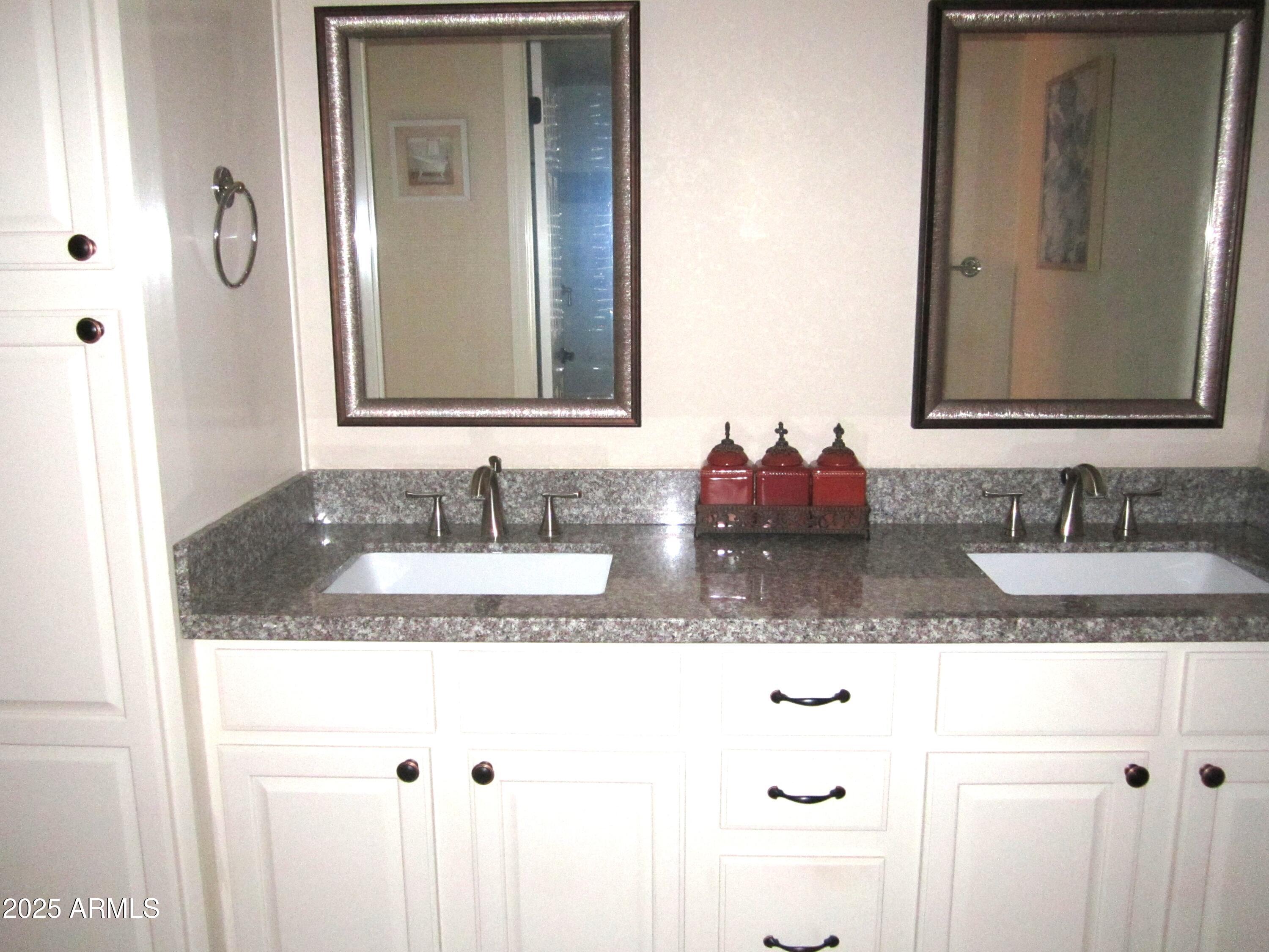 12222 North Paradise Village Parkway West, Unit 325 Phoenix, AZ 85032 - Photo 9 of 28 a bathroom with sink granite and a mirror