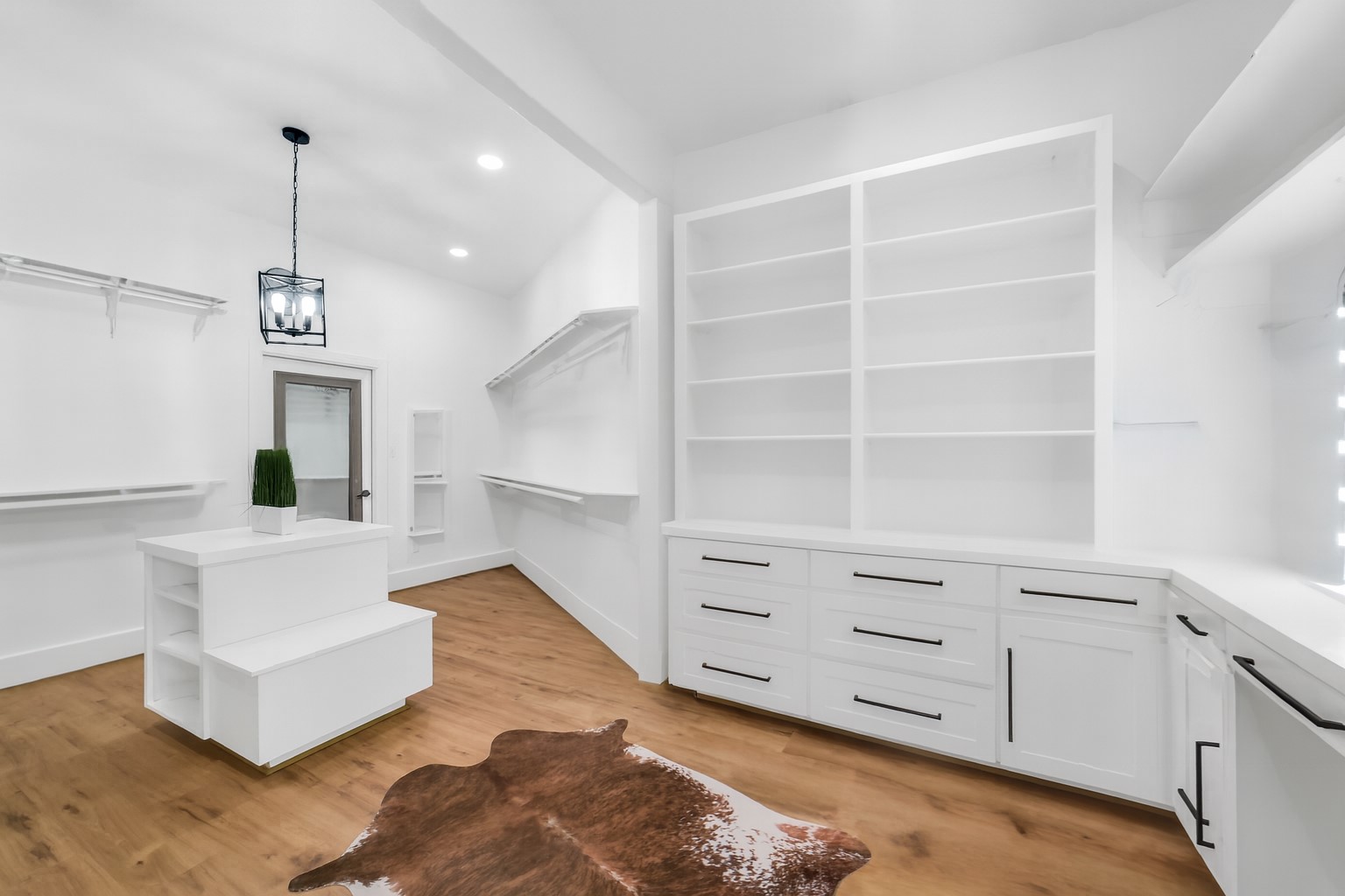 3103 Brundrett Road Wallis, TX 77485 - Photo 26 of 50 Custom walk-in closet with shelving, drawers, and a small island.