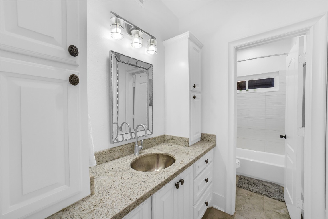 3103 Brundrett Road Wallis, TX 77485 - Photo 31 of 50 a bathroom with a granite countertop sink and a mirror