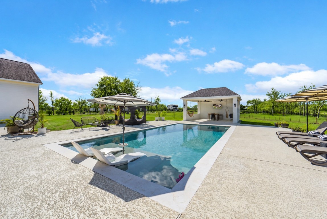3103 Brundrett Road Wallis, TX 77485 - Photo 37 of 50 a view of a swimming pool with a patio
