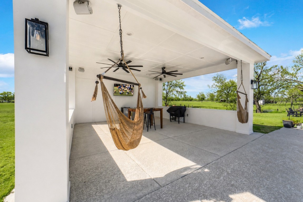 3103 Brundrett Road Wallis, TX 77485 - Photo 38 of 50 Covered patio offering shade, seating, and wide-open views.