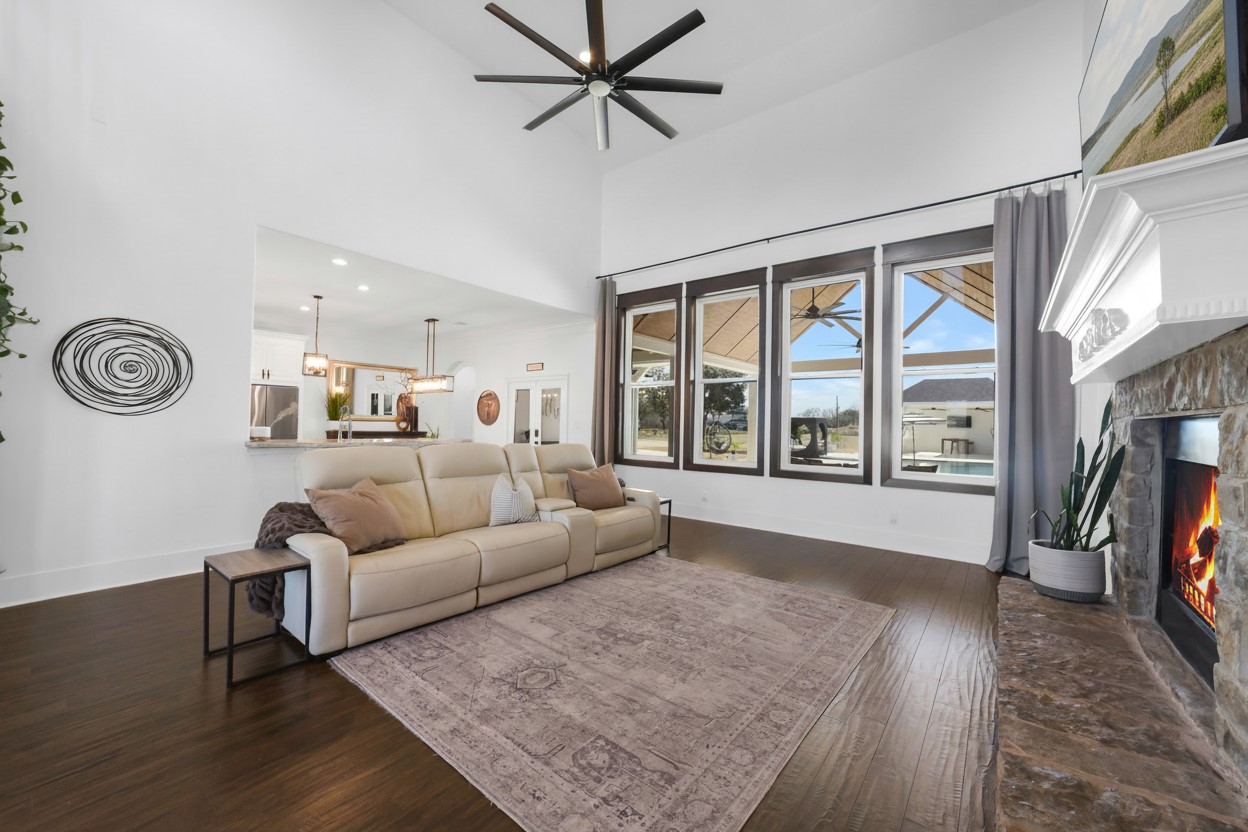 3103 Brundrett Road Wallis, TX 77485 - Photo 7 of 50 Bright living room anchored by a stone fireplace and expansive windows.