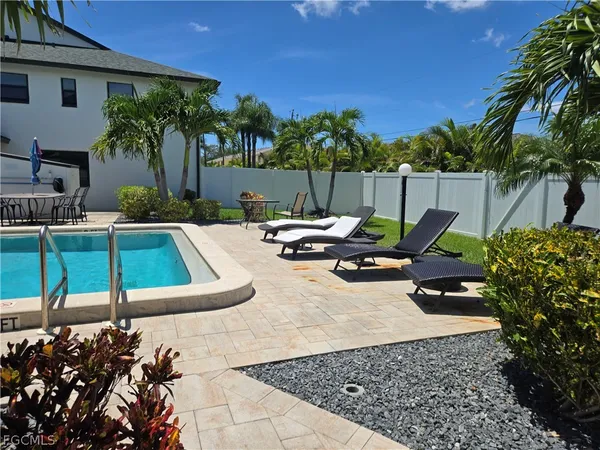a view of a porch with furniture and floor to ceiling window