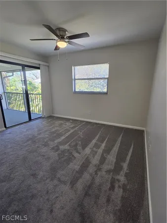 a bathroom with a granite countertop toilet sink and mirror