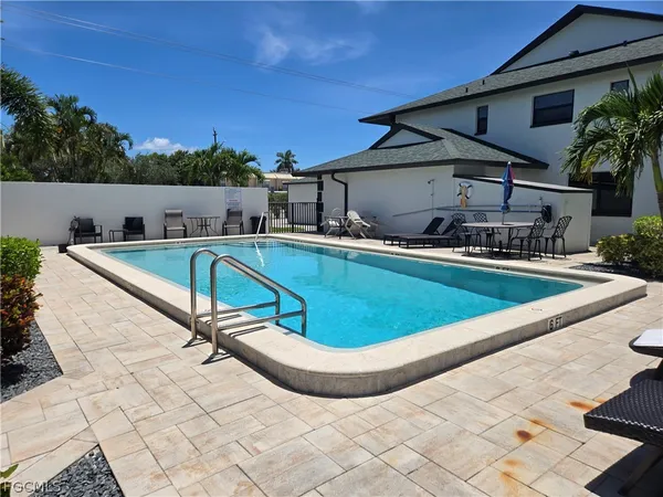 an empty room with a ceiling fan and carpet