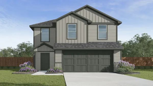 a front view of a house with a garden and yard