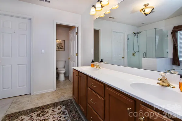 a spacious bathroom with a double vanity sink and mirror