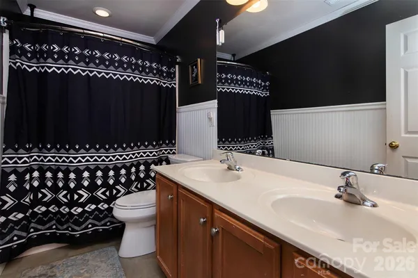 a bathroom with a sink a mirror and a toilet