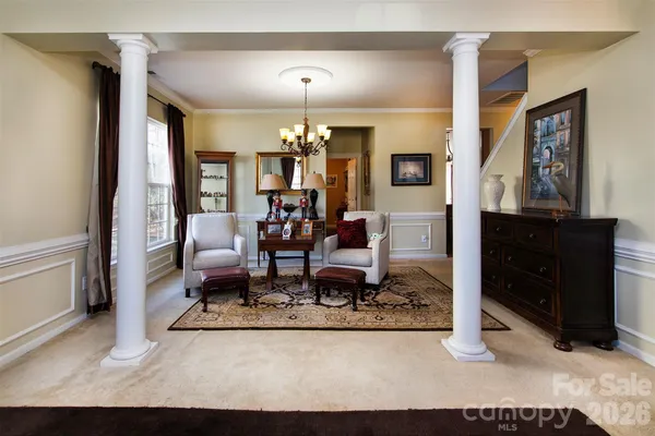 a living room with furniture and a dining table