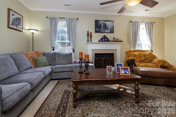a living room with furniture and a fireplace