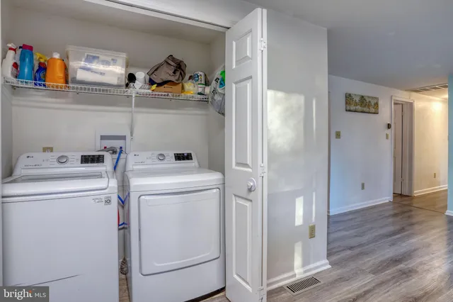 a view of storage and utility room with washer and dryer