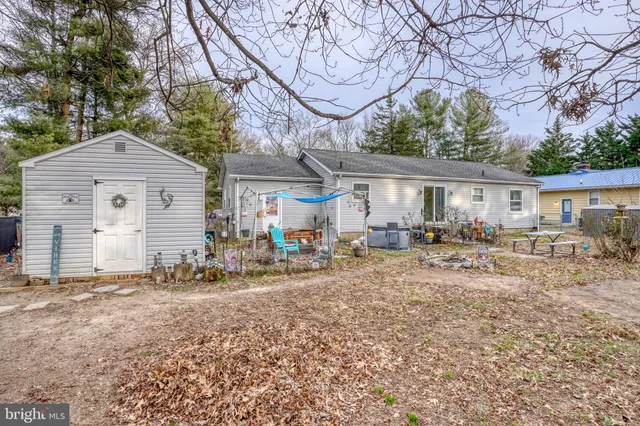 a front view of a house with yard patio and fire pit