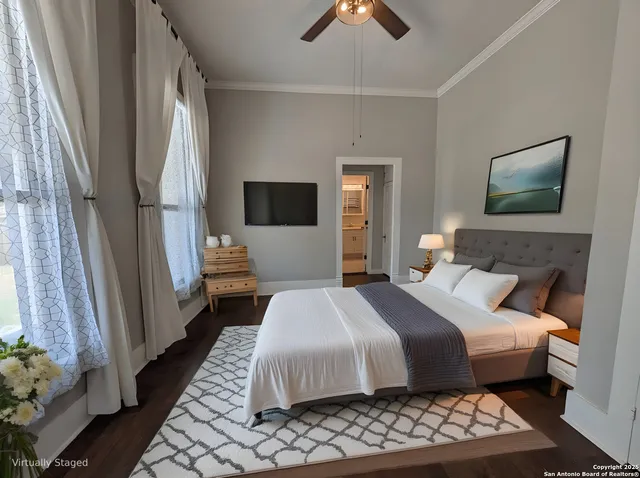 a bedroom with bed and wooden floor