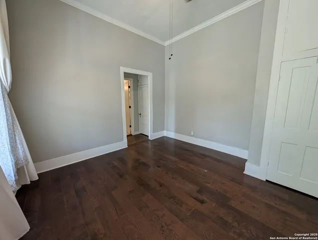 an empty room with wooden floor and closet
