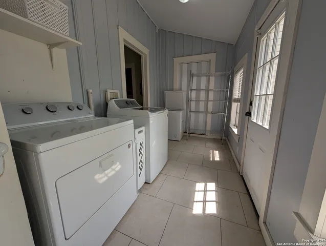 a bathroom with a sink a toilet and a large mirror