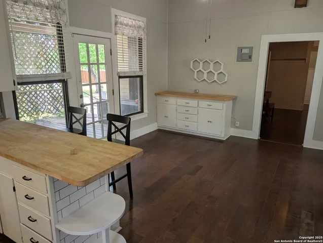 a view of a room with furniture and window