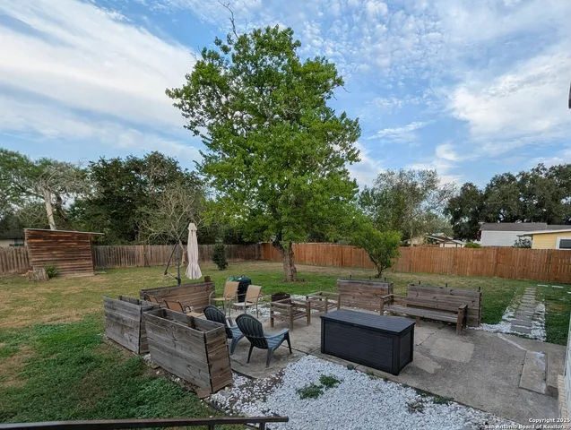 an outdoor sitting area with couch and wooden floor