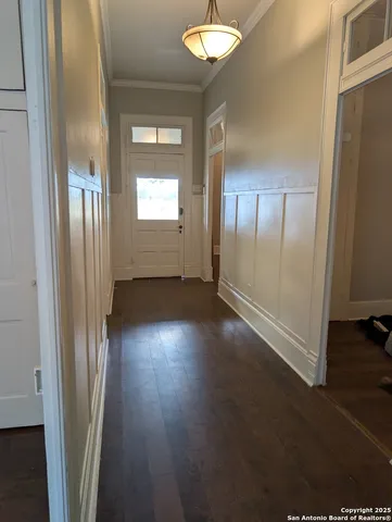 a view of a hallway with wooden floor
