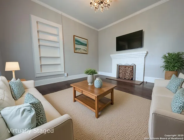 a living room with furniture a fireplace and a flat screen tv