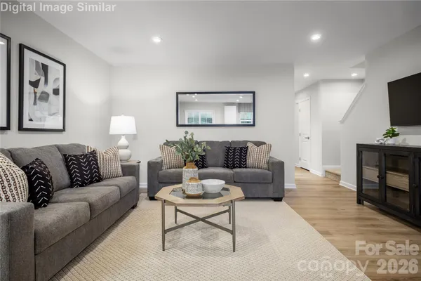 a living room with furniture a couch and a flat screen tv