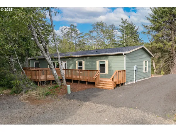 a view of a house with a yard and deck