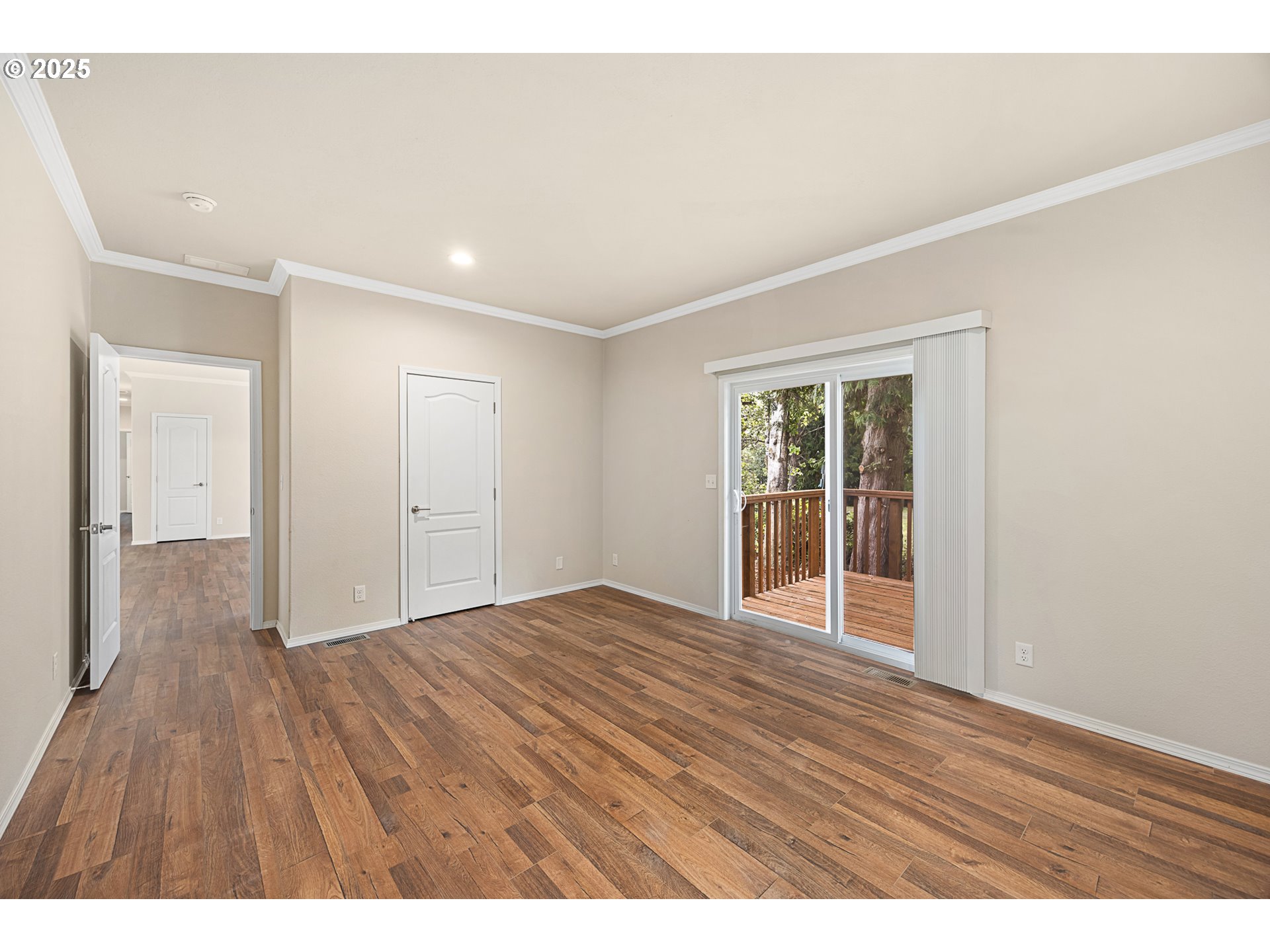 352 North Falcon Street Rockaway Beach, OR 97136 - Photo 12 of 32 a view of an empty room with wooden floor and a window