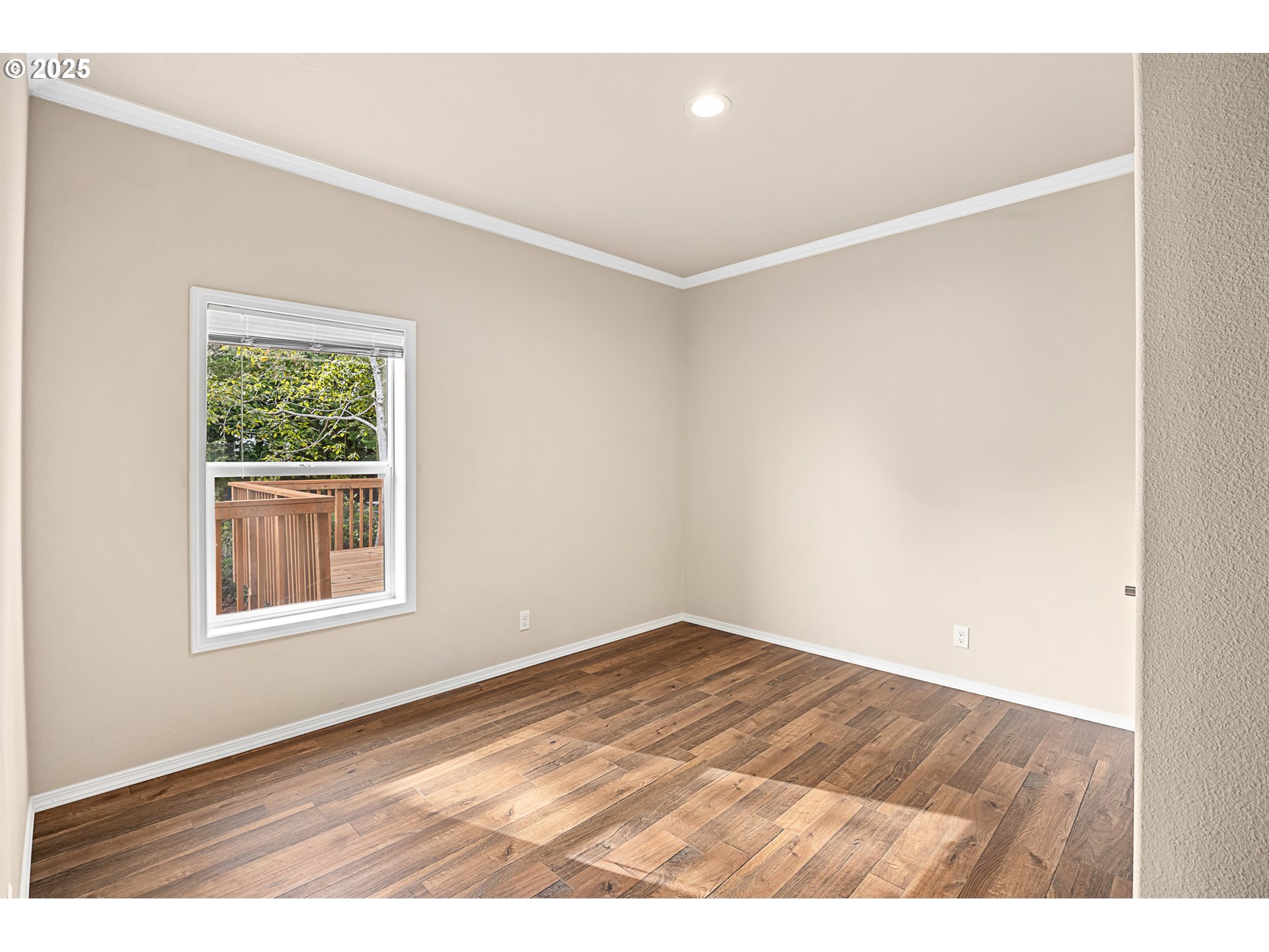 352 North Falcon Street Rockaway Beach, OR 97136 - Photo 18 of 32 an empty room with wooden floor and windows